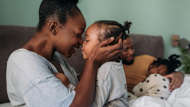 18-month sleep regression, mother with little toddler girl and dad with another girl in background