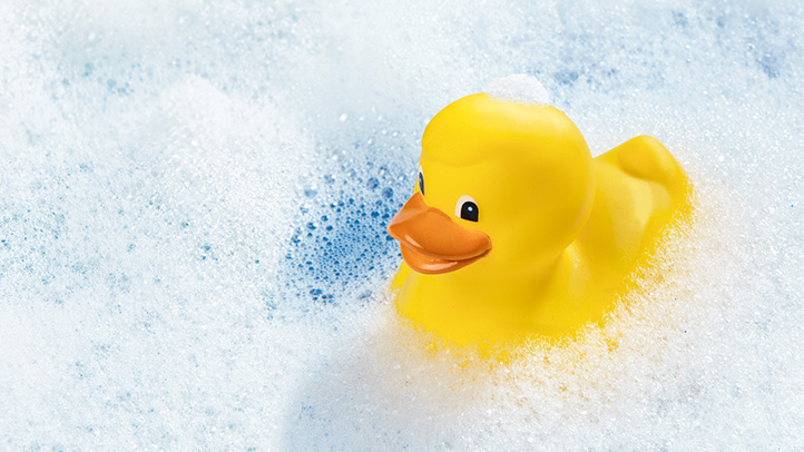 how to bathe your newborn baby, baby's first bath, rubber ducky in bubble bath