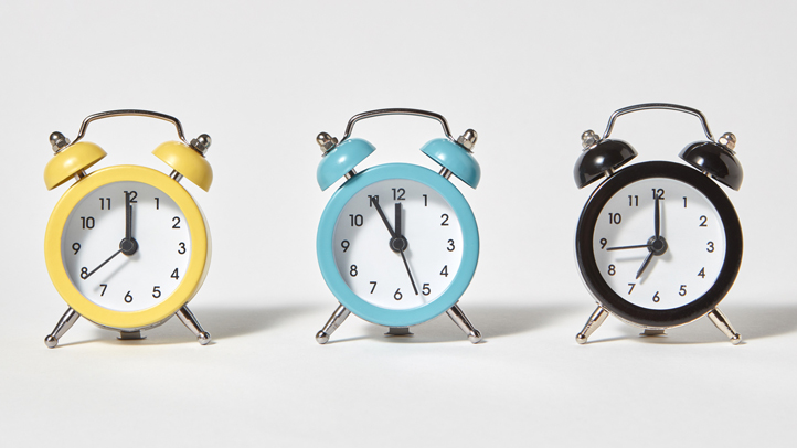 bedtime fading method of sleep training, three multi-colored alarm clocks in a row
