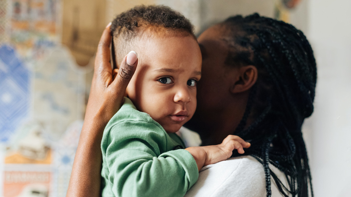 toddler keeps getting out of bed, toddler climbing out of crib, mom carrying toddler back to bed