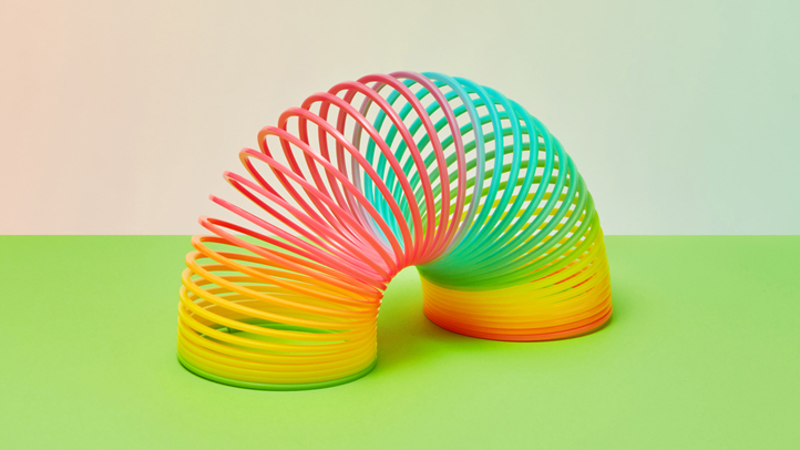 postpartum pelvic pain, colorful slinky on a bright green surface