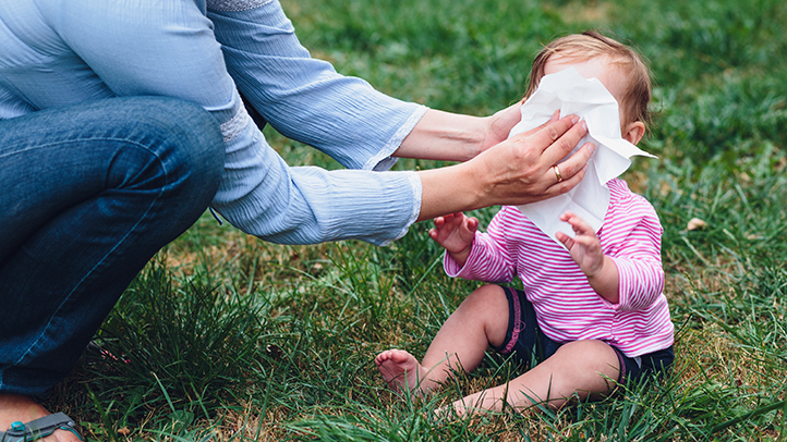 baby blowing nose in grass, stuffy nose in babies and toddlers