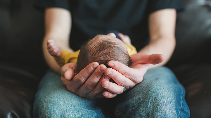 sunken fontanel, sunken soft spot, dad holding baby on lap dad cradling baby's head