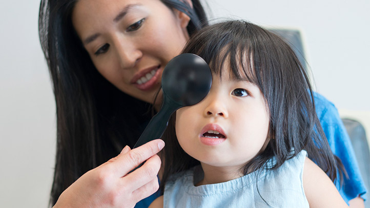 toddler eye exams, toddler girl getting vision screening done