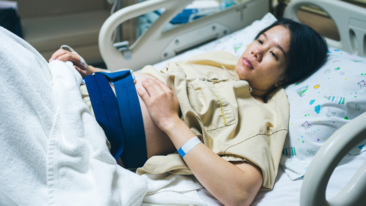 uterine inversion, woman in labor with fetal monitor