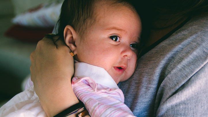 guide to well-baby visits, parent holding new baby